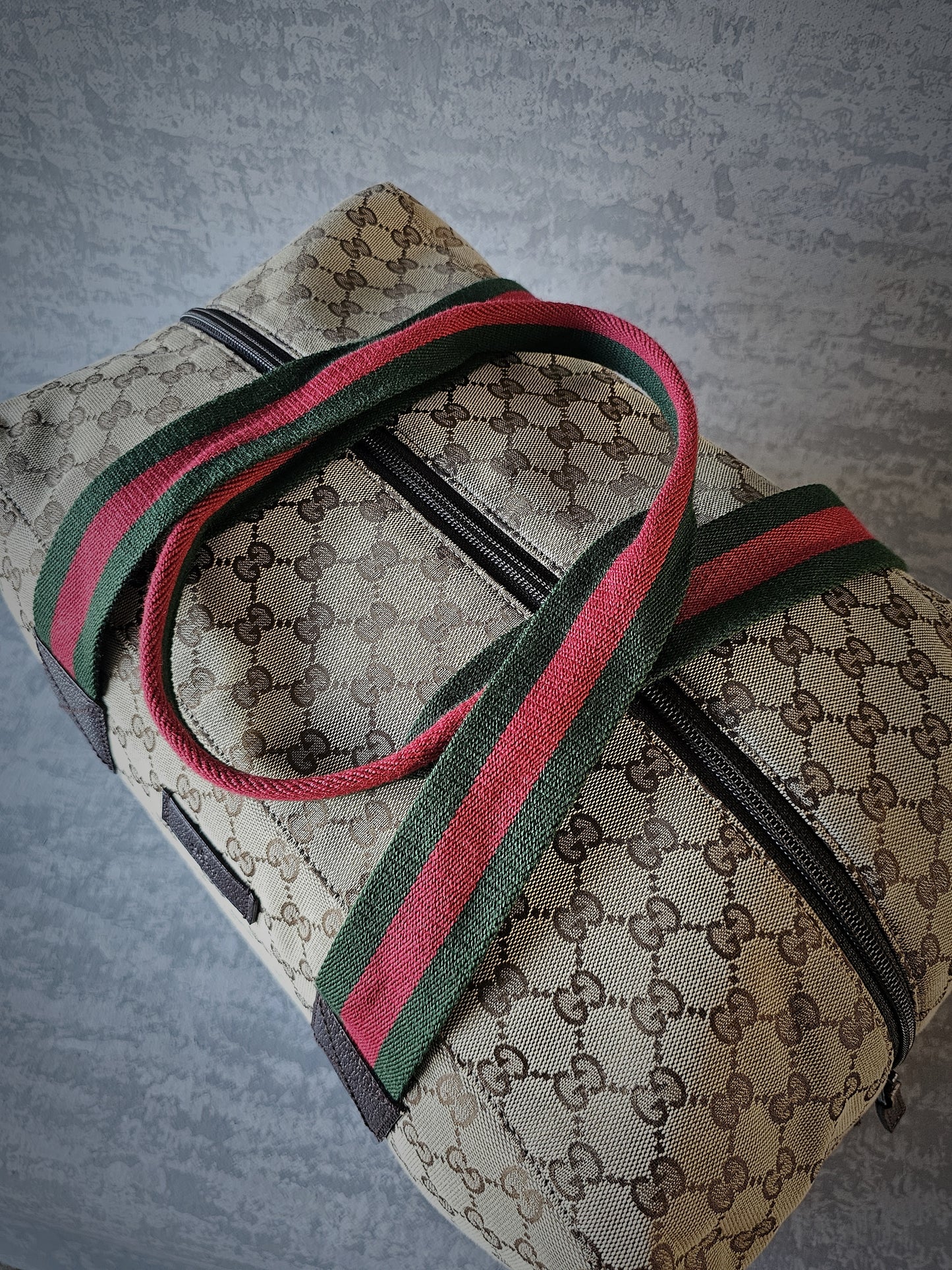 GUCCI GG Leather and webbing-trimmed Supreme Monogram Duffle Bag