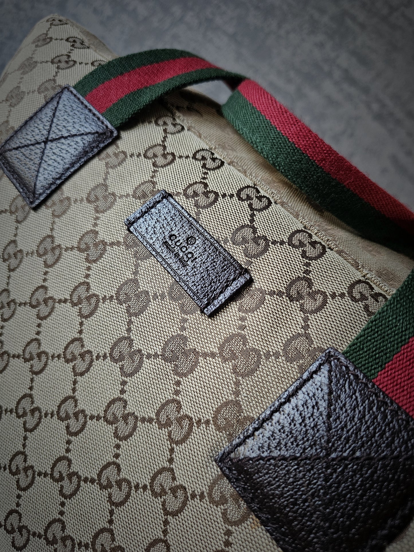 GUCCI GG Leather and webbing-trimmed Supreme Monogram Duffle Bag